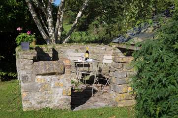 The wonderful old stone pigsty is now a sheltered place for guests to enjoy a glass of wine.