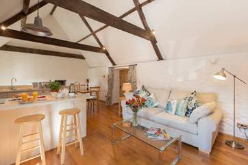There is a comfortable sofa at the heart of the room