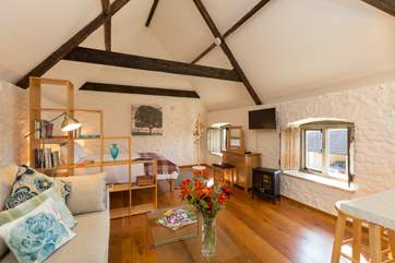 The open plan first floor has plenty of light and is divided into sleeping, relaxing and kitchen/dining areas.