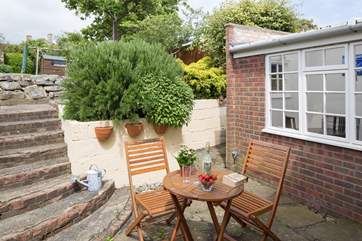 The patio is very sheltered and has views to the top of the back garden. Please supervise children on the steps.