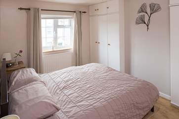 The master bedroom has a 5' bed, fitted wardrobes give a spacious feel, the window looks out to the front of the cottage.