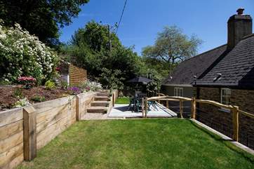 There is a grassed area as well as a slate patio on the lower terrace.