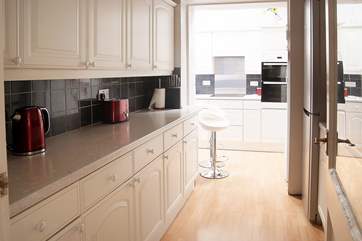 The spacious L-shaped kitchen is fully equipped for the keenest cook.