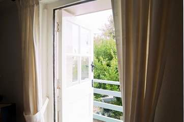Open the door onto the balcony to sit a while before heading into town for dinner.