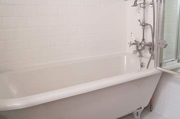 The stylish bathroom has a deep claw-foot bath and rainfall shower head, so shower or soak, it's going to be good.