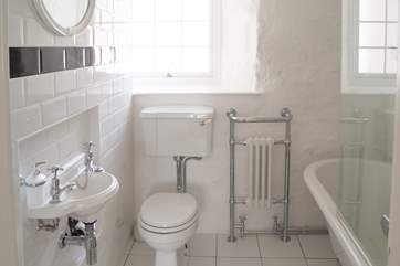 The super bathroom with the cutest sink and a gorgeous roll-top bath.