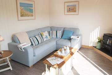 The open plan living-room has a comfy corner sofa.