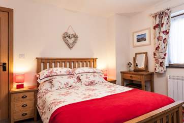 The pretty and spacious bedroom with en suite shower-room.