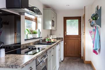 The kitchen is not only well-equipped but also very stylish.