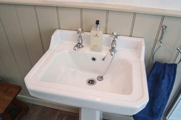 The bathroom fittings reflect the cottage's heritage.