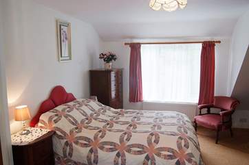 The bedroom is comfortably furnished with a double bed and has plenty of storage.