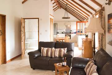 The open plan living-room is light and spacious with lovely high ceilings.