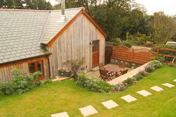 This delightful cottage has the look and character of a traditional wooden cabin.