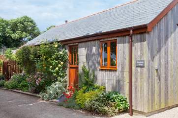 The delightful cottage has the look and character of a traditional cabin.