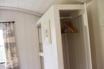 There is even room for hanging space built behind the bed.