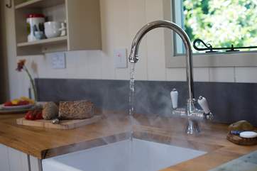 Of course there is hot running water to your kitchen sink.