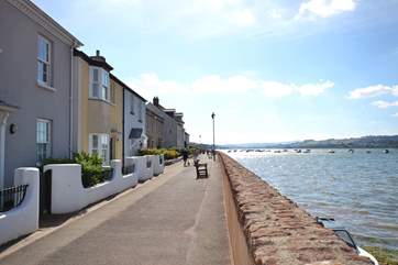 The front of the cottage (second one in from the left, painted yellow) and the view from the front door. Please note the path in front is not accessible by cars.