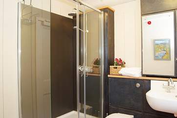 The shower-room has a super-size shower cubicle and a rainfall shower head.