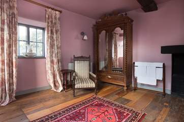 Another view of the four-poster bedroom, which has views over the castle courtyard and the museum.