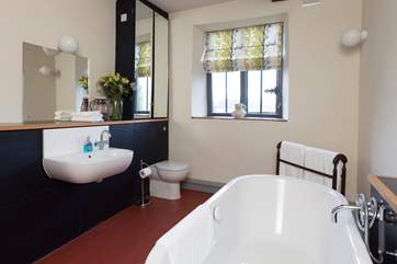 This bathroom is on the third floor. The bath is free-standing and there is a hand held shower.