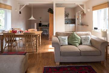 Looking from the living-room towards the kitchen and dining area. The door leads out to the patio and up to the meadow from the kitchen.