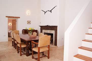 The entrance hall and grand dining-table - a double height room with stairs leading up to the open plan living space on the first floor.