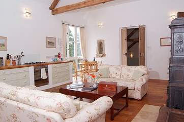 The living area on the first floor has plenty of room for the kitchen, a breakfast-table and two sumptuous sofas either side of the wood-burner.
