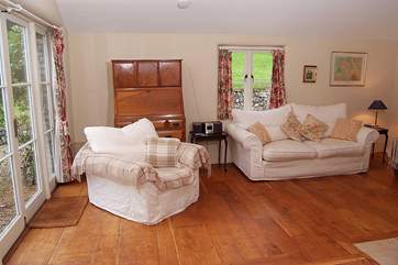 The second sitting-room or snug is where the TV is. There is another wood-burner in this room, and French windows to the patio and garden.
