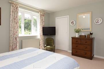 This room has the luxury of its own TV, and there is plenty of storage space too.