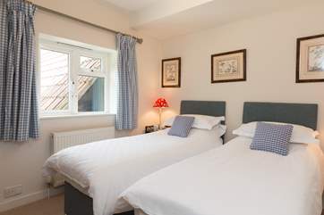 Another view of the twin bedroom which looks out to the side of the cottage, with garden views.