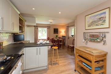 There is an open plan kitchen/dining room with garden views.