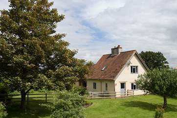 Detached Hillcombe Cottage has a really large and fully enclosed garden, countryside views, and private off road parking.