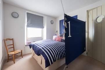 A canvas sail screens the bed.