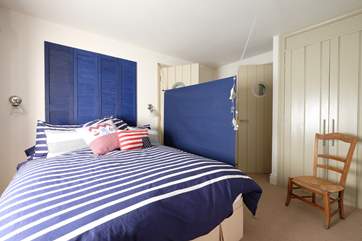 A door leads off to the shower-room and stairs to the living-room above.