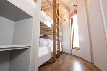 The triple-bunk bedroom is in the smaller yurt.