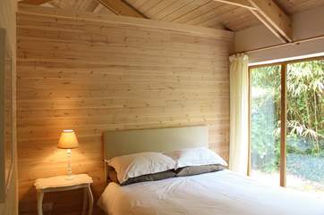 The double bedroom with king-size bed and with the roof open to the rafters above there is an increased feeling of air, light and space.