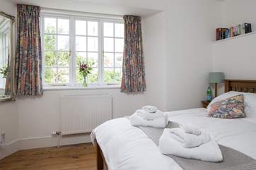 The master bedroom looks out towards the village and the little nature reserve across the river where all are welcome.