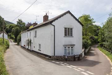 Another view of St Giles cottage on a quiet lane set back from the village, with a little river beside.