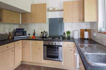 There is a modern kitchen with separate access to the outside.