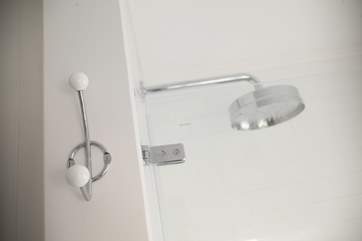 A rainhead shower above the bath.