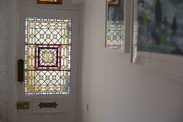 There are many original features in the cottage, including this most gorgeous stained glass panel that greets you on arrival.