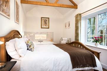 The bedroom takes full advantage of the wonderful setting