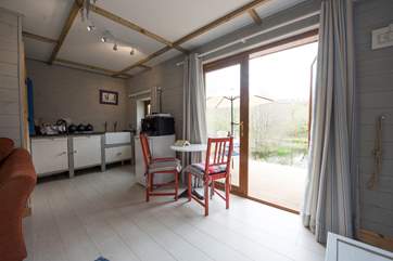 The little dining-table has a lovely view over the lake and valley beyond.