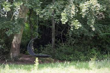 There is a swing hammock in the lower meadow.
