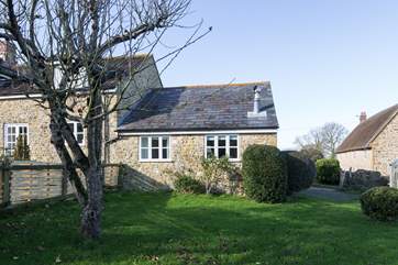 Badgers Cottage is all on one level and has its own mature enclosed garden. The helpful Owners live in the farmhouse to the right of the photo.