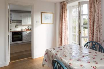 A view of the kitchen from the sitting/dining- room, please mind the step. The kitchen is being replaced in Spring 2019 creating a combined kitchen and dining area.