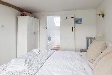 The master bedroom has a generous 5ft bed with gorgeous linens and an en suite bathroom.