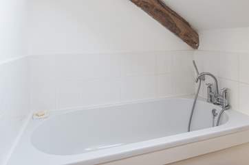 The spacious en suite bathroom has a hand held shower.