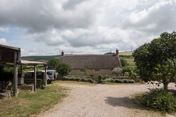 Looking down through the farmyard, the owners' house is at the bottom and the cottages to the right of the photo.