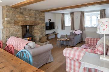 The open plan sitting room/dining room has three sofas to choose from and a cosy wood burner. The sitting room is being updated early in 2019.